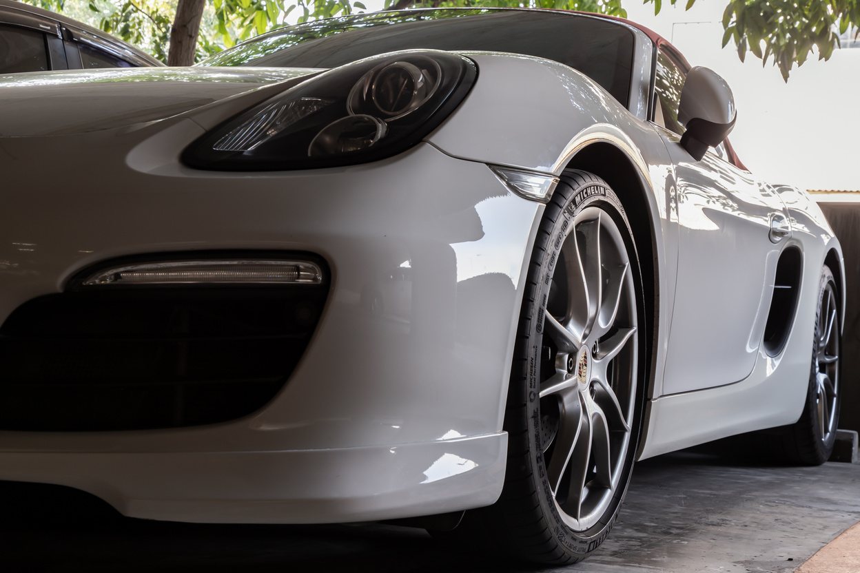 Close-up of Car Headlights and Car Wheel of White Porsche Sports